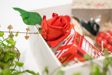 Gift in red box and greeting card and lettering with red rose 