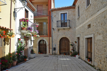 Fototapeta na wymiar A narrow street among the old houses of an ancient Italian town