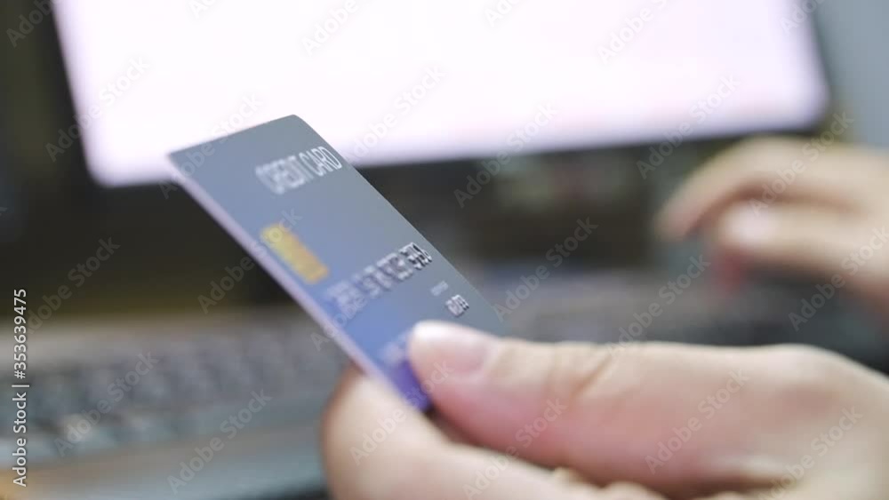 Poster close up shallow focus hand hold credit card and other hand key in keyboard. background for e-commer