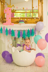 Obraz premium Little girl at purple dress. first birthday