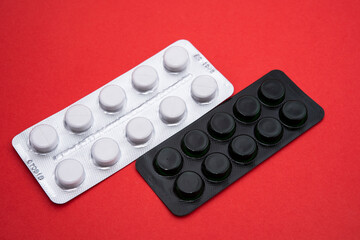 medicines in white and black packaging