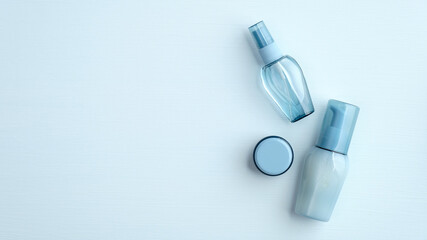 Hyaluronic acid collagen cosmetics packages on blue background. SPA natural organic water based beauty products set. Flat lay, top view.