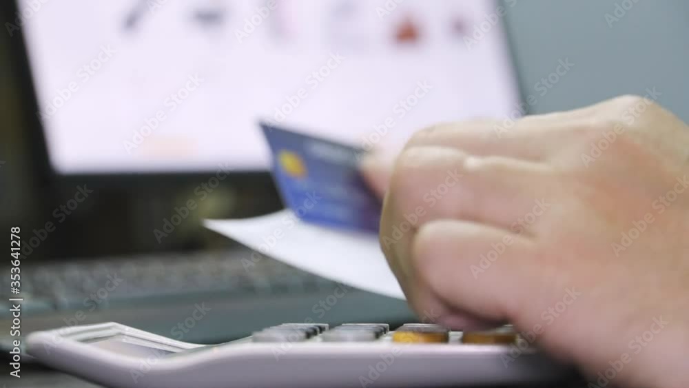 Poster close up Shallow focus hand hold Credit Card and other hand key in on calculator. Background for E-commerce and online shopping concept.
