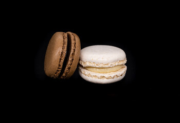 Sweet white and brown french macaroon or macaron dessert on white background. White and brown cookies