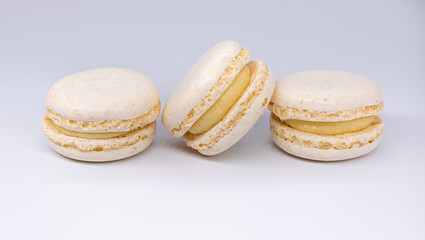 Sweet white french macaroons or macaron dessert isolated on white background. White biscuit