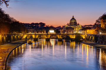 Fototapeta na wymiar Sunset over the St. Peters Basilica and the river Tiber in Rome