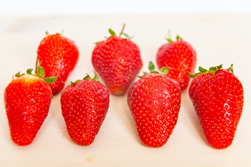 Ripe strawberries on wooden surface