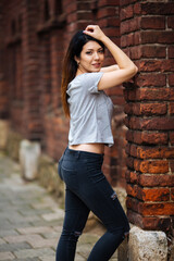 beautiful girl near the wall in jeans