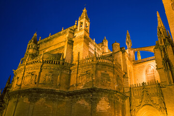 Fototapeta na wymiar Night view of the spiers of the gothic cathedral of Seville, Spain.