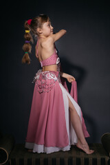 A little girl dressed as an belly dancer
