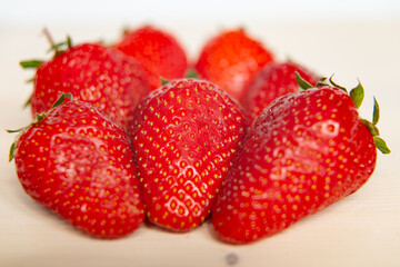 Ripe strawberries on wooden surface