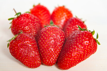 Ripe strawberries on wooden surface