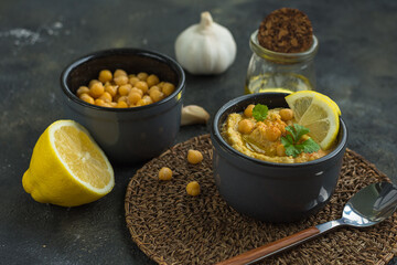 Hummus is a traditional appetizer made from chickpea puree the products it is made from are chickpeas, lemon, garlic and olive oil, horizontal arrangement