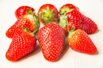 Ripe strawberries on wooden surface
