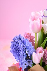 Beautiful elegant spring bouquet for greeting on pink background, selective focus, copy space. Bunch of tender tulips, eustoma flowers and hyacinthus. Romantic bouquet of flowers. Mother’s Day