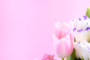 Obraz premium Beautiful elegant spring bouquet for greeting on pink background, selective focus, copy space. Bunch of tender tulips, eustoma flowers and hyacinthus. Romantic bouquet of flowers. Mother’s Day