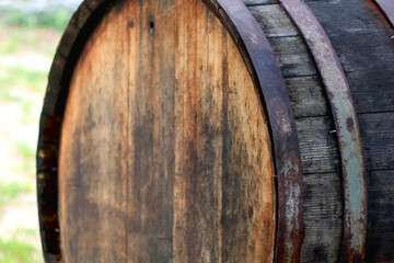 Traditional wooden wine barrel in the countryside. Selective focus.