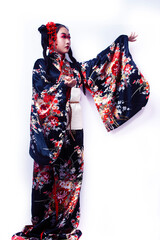 young pretty geisha in black kimono with sakura, asian ethno closeup on white background isolated