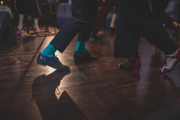 Dancing shoes of young couple dance retro jazz swing dances on a ballroom club wooden floor, close...