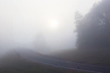 Road with fog in the morning. Misty highway.