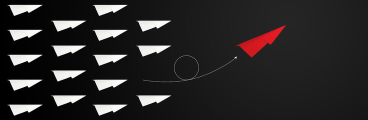 Individual red paper plane in undergoing direction group on dark black chalkboard background concept for teamwork think different solution way. Change vision way for new business identity branding.