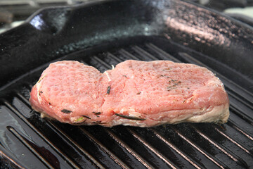 Grilling steak on a grill pan. Chef making steak. Beef tender steak on the grill pan. 