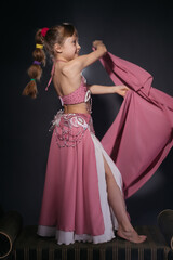 A little girl dressed as an belly dancer