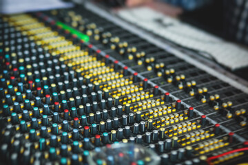 Sound editor engineer working at studio with mixing panel, mixing music and sound, stage sound...