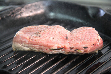 Grilling steak on a grill pan. Chef making steak. Beef tender steak on the grill pan. 