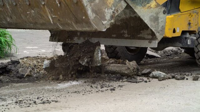 Bulldozer doing road renovation works and onlookers watching it