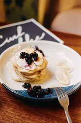 Pancakes with banana and berries, film photography - 353650860
