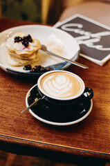 Cappuccino and pancakes with berries, film photography - 353650862