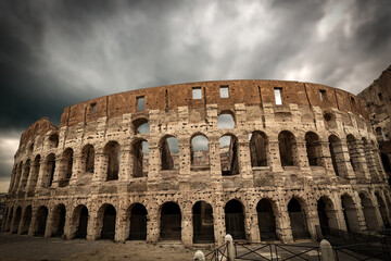 Fototapeta na wymiar Facade of the Rome Coliseum with cloudy sky. Amphitheatrum Flavium 72 a.D. Latium, Italy, Europe 