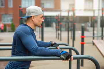 handsome young man in sportswear is training outdoors