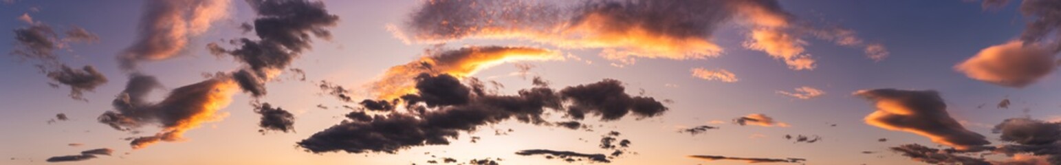 Sunset dramatic sky background and colorful dark clouds.