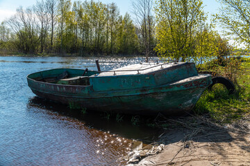 Old fishing boat in the early morning on the shore of the Bayou of lake Ladoga near the city of New Ladoga.