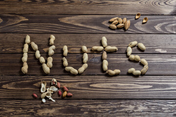 Nuts spelling nuts on a wooden table.