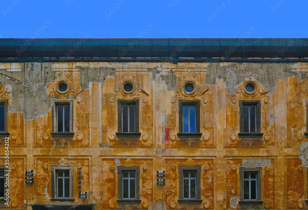 Wall mural detail of old building facade of bishop's palace in front of cathedral in historical centre of naple