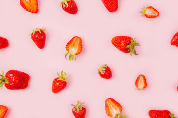 Seamless pattern with strawberry on pink and white background.