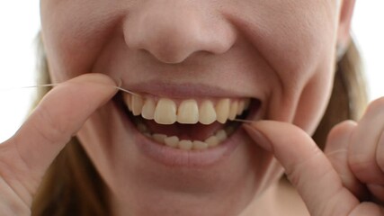 Young girl flossing her teeth