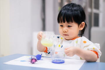 Asian toddler girl is painting water color. toddler activity at home. - 353655446