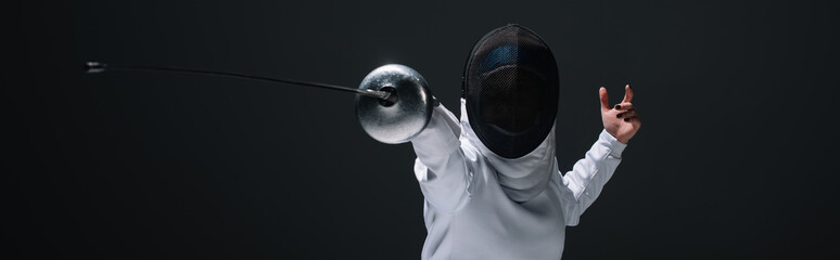Panoramic orientation of fencer training with rapier isolated on black