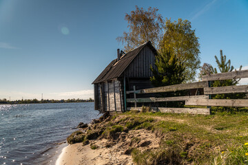 A picturesque fishing house with a washed-out Foundation on the Bank of the Volkhov river at the exit to lake Ladoga.