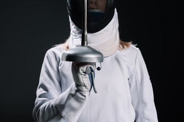 Cropped view of fencer holding rapier isolated on black