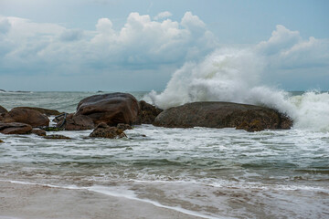 Rocks and big waves on the beach in Yala National Park in Sri Lanka, stormy day.
