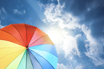 Modern color umbrella against blue sky. Sun protection