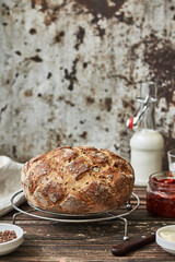 Freshly baked bread with flax seeds, butter, sun-dried tomatoes and milk. Snack or breakfast	