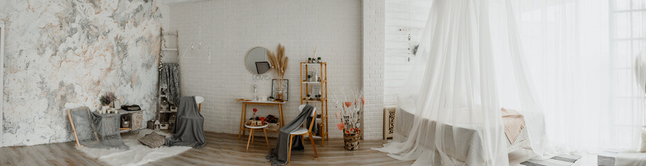 Panoramic view of photo studio with vintage decoration: bed, chairs, table, mirror, scale, typewriter.