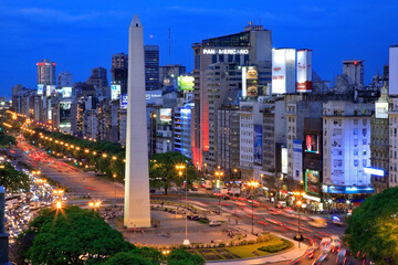 Buenos Aires Obelisk at dusk, along Corrients Avenue, with city lights. Buenos Aires, Argentina