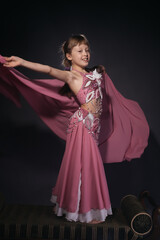 A little girl dressed as an belly dancer